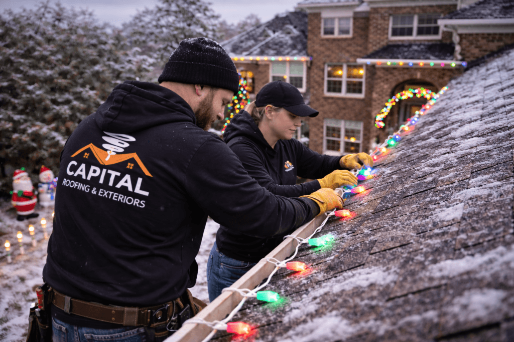 christmas lights installation on snowy evening