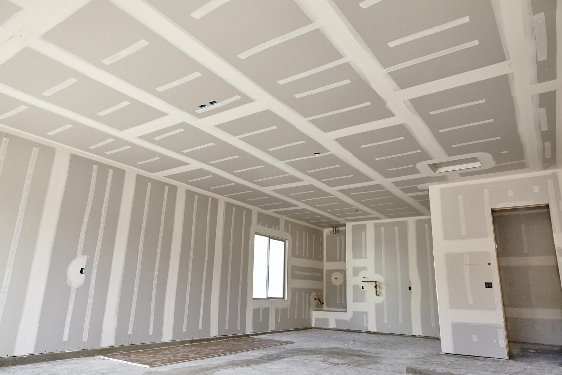 Drywall taped and mudded, ready for finishing