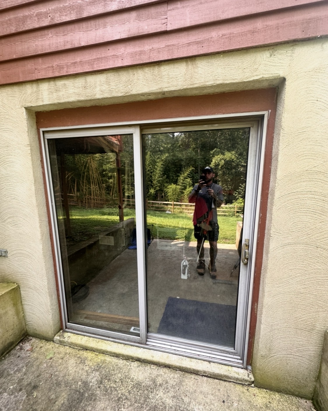 Old aluminum sliding glass patio door before replacement